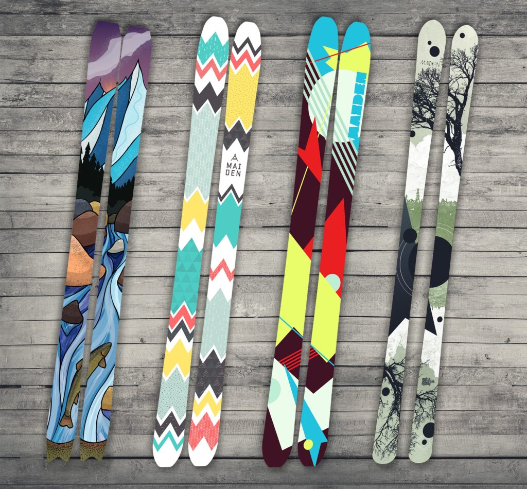 Four ski topsheet designs: mountain stream with trout, chevrons, retro abstract, and tree